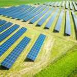 Solar panels on green field. Photovoltaic farm. Renewable energy in Poland