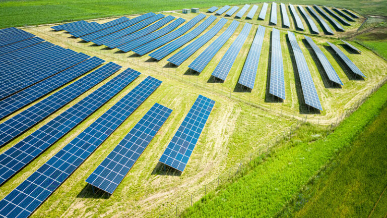 Solar panels on green field. Photovoltaic farm. Renewable energy in Poland