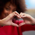 Cropped shot of an unrecognizable woman forming a heart shape with her fingers