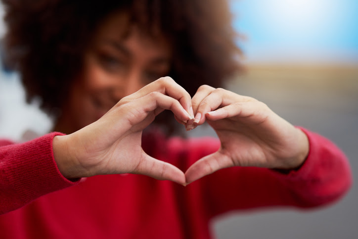 Cropped shot of an unrecognizable woman forming a heart shape with her fingers