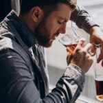 Man drinker depressed with bottle of whiskey