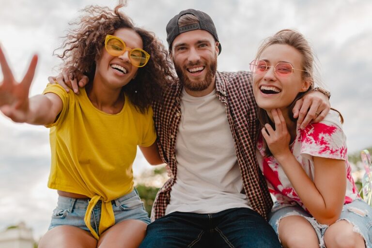 happy young company of smiling friends excited in park, man and women having fun together, colorful summer hipster fashion style, smiling