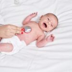 adorable-caucasian-baby-having-heart-examination-with-stethoscope-crying-bedroom