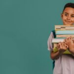 front-view-child-holding-pile-books-copy-space-23-2148764071