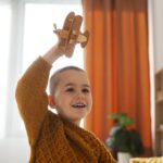 front-view-boy-playing-home