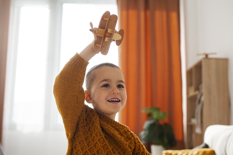 front-view-boy-playing-home