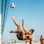 Young Brazilian woman play a game of footvolley